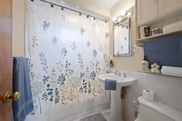 a bathroom with a sink toilet and shower