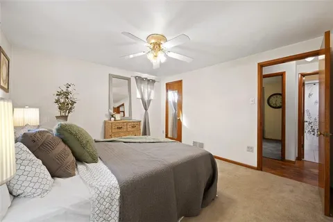 a bedroom with a large bed and a chandelier
