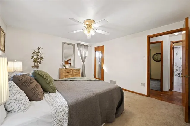 a bedroom with a large bed and a chandelier