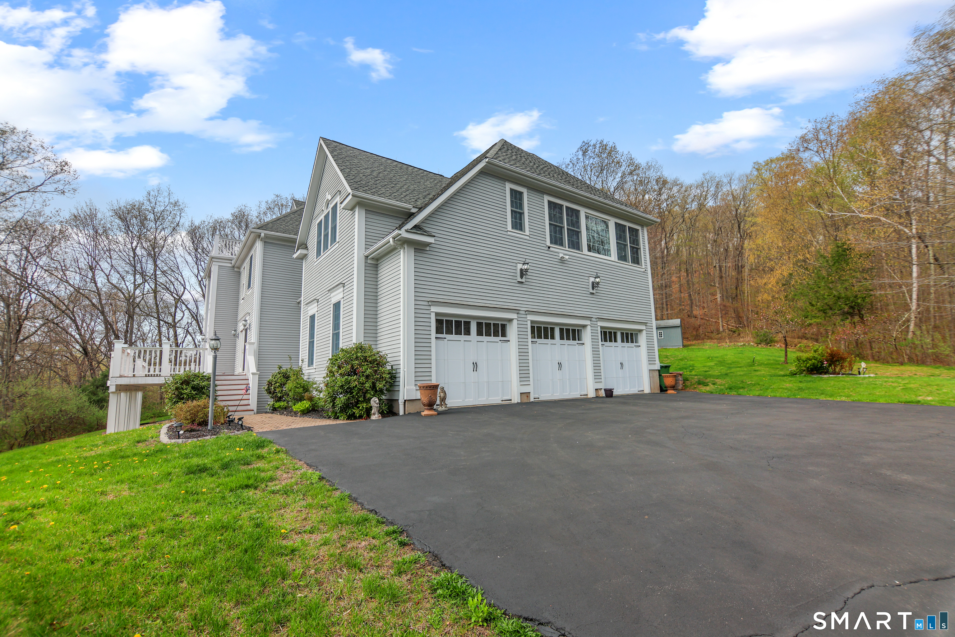 83 Bayberry Hill Road Avon, CT 06001 - Photo 5 of 34 a front view of a house with a yard and garage