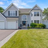 a front view of a house with a yard and garage