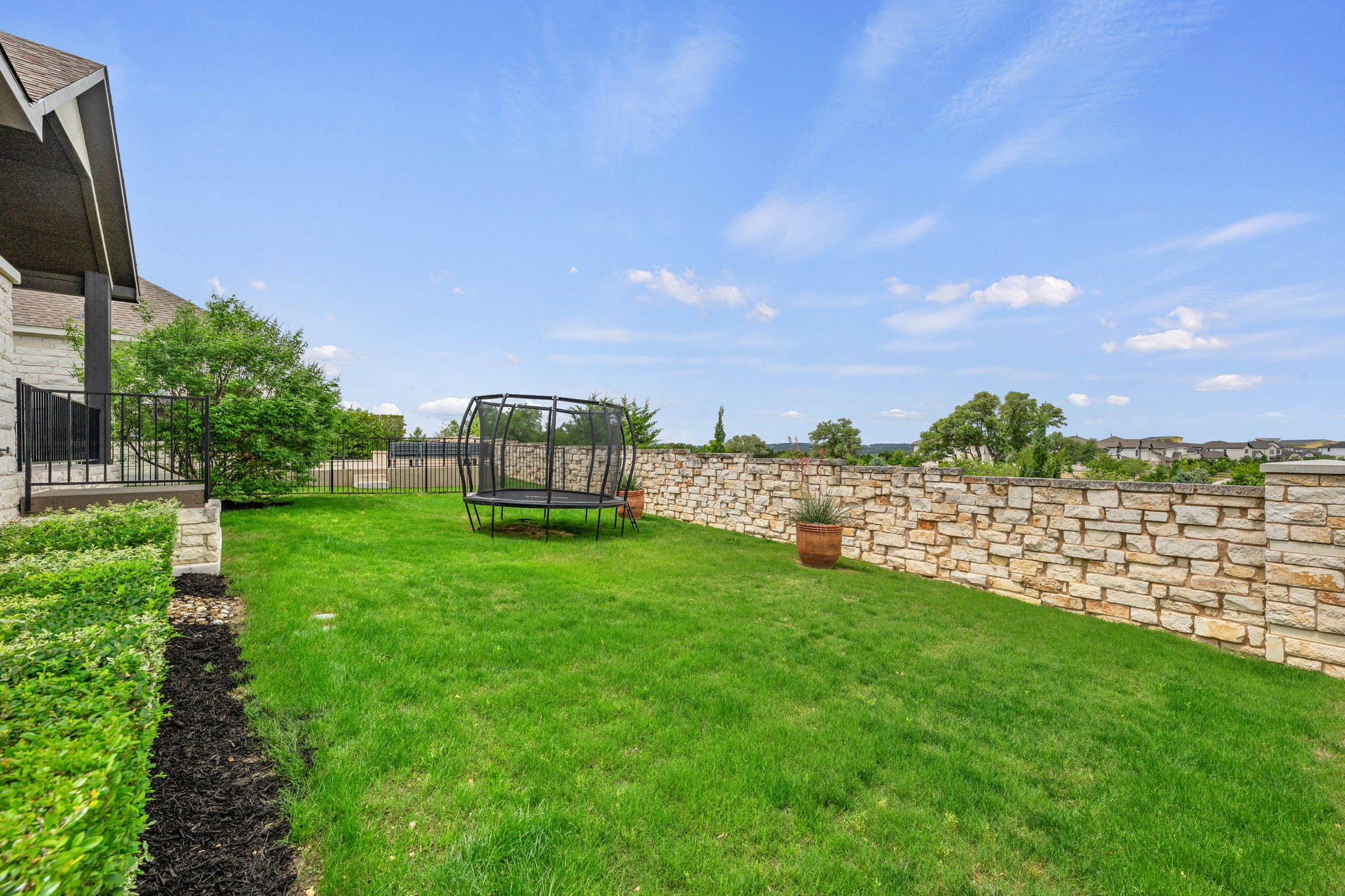 510 Elworth Path Austin, TX 78738 - Photo 27 of 40 a view of a garden with a building in the background
