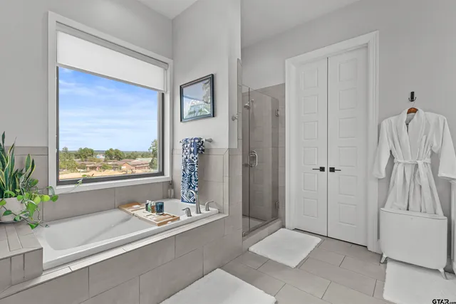 a living room with a large window and a glass door