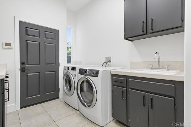 a spacious bedroom with a bed a mirror and a flat tv screen