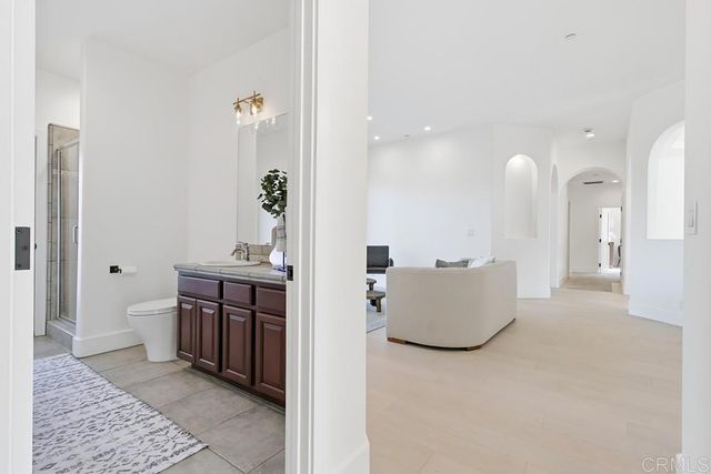 a spacious bathroom with a granite countertop tub sink and mirror