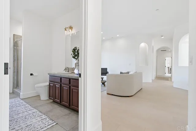 a spacious bathroom with a granite countertop tub sink and mirror