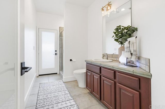 a bathroom with a tub sink shower and mirror