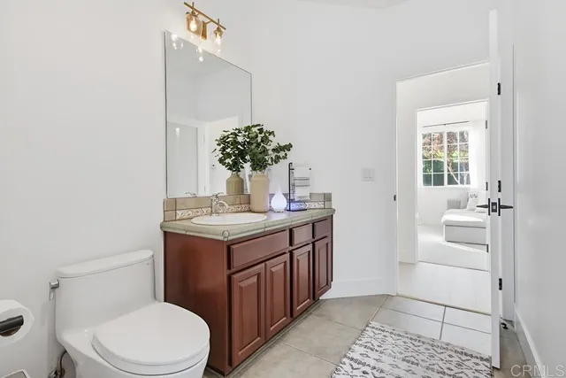 a living room with furniture a flat screen tv and a window