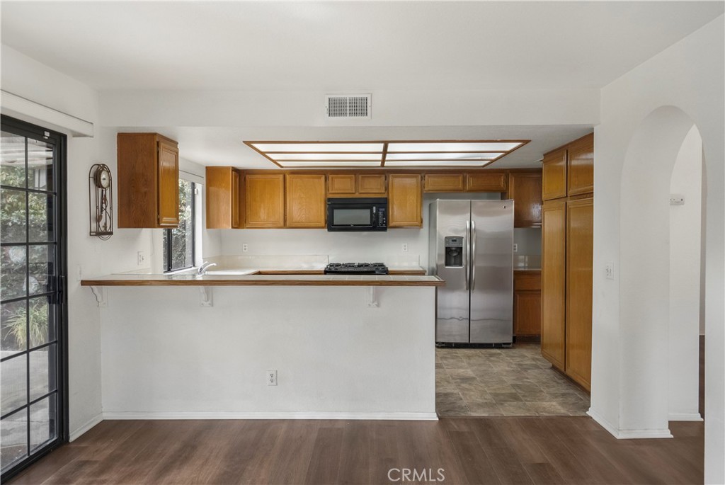 2176 Glenview Terrace Riverside, CA 92506 - Photo 11 of 36 a kitchen with stainless steel appliances a refrigerator and cabinets