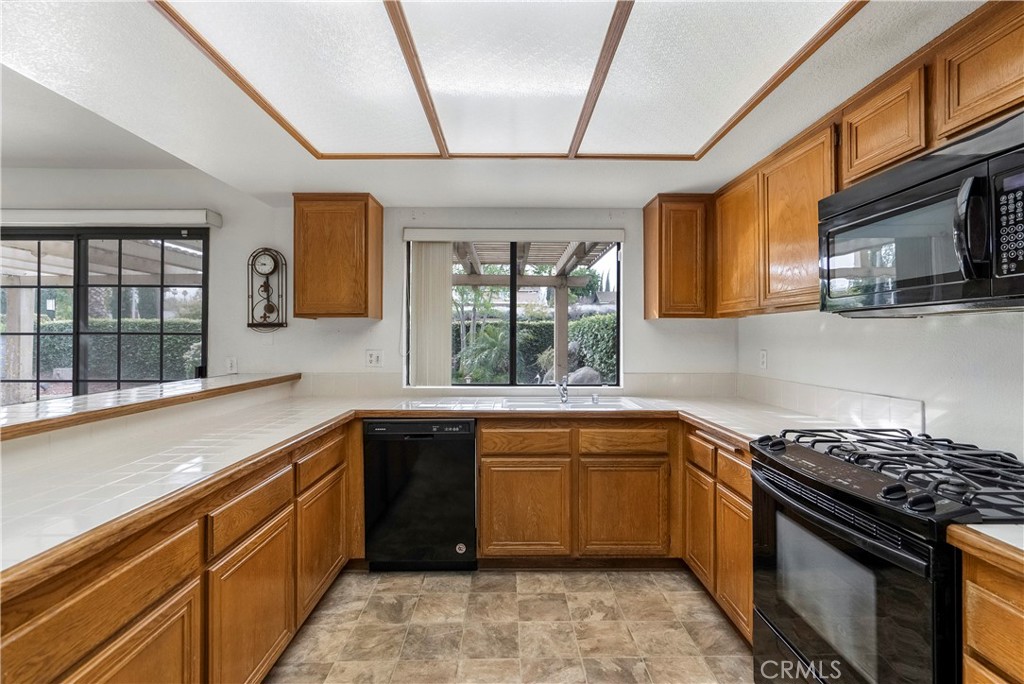 2176 Glenview Terrace Riverside, CA 92506 - Photo 14 of 36 a kitchen with a sink stove and microwave