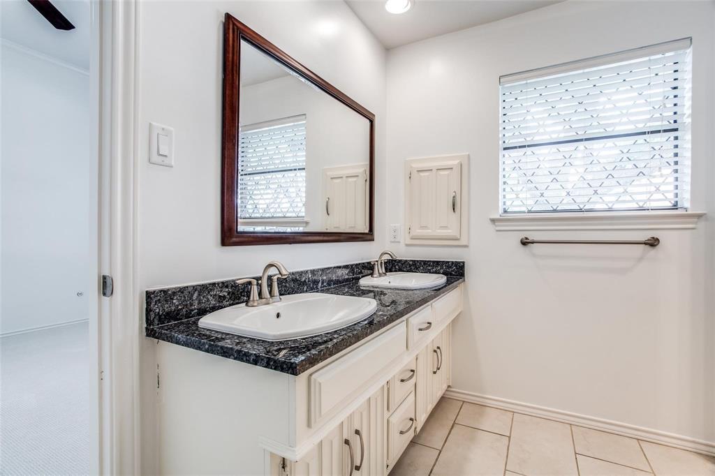 6926 Northwood Road Dallas, TX 75225 - Photo 27 of 29 a bathroom with a granite countertop sink and a window