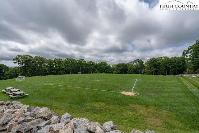 a view of field with trampoline in background
