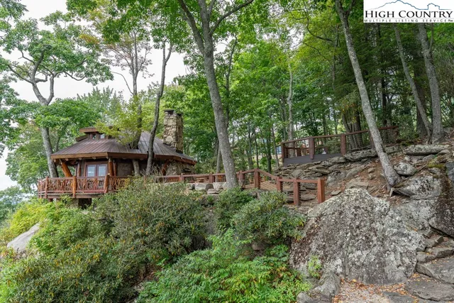 a view of a chairs and table in the backyard