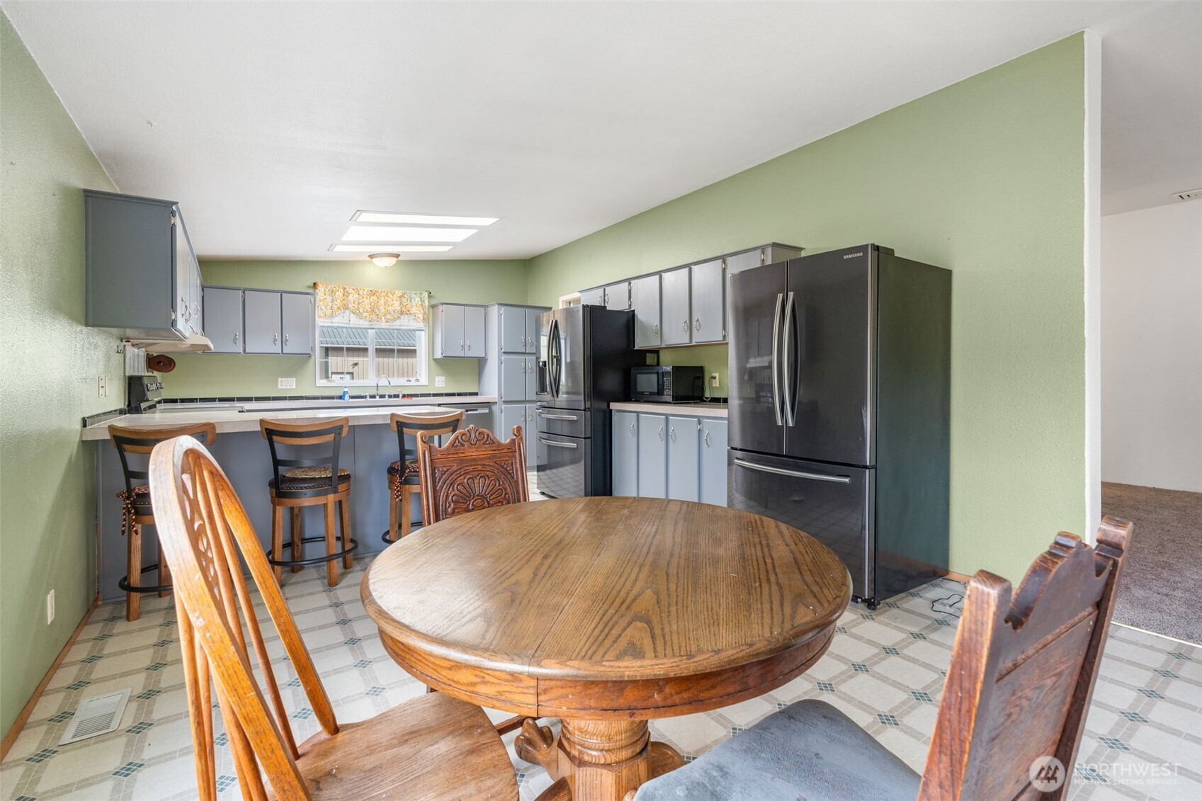 1332 Centralia Alpha Road Chehalis, WA 98532 - Photo 20 of 40 a kitchen with stainless steel appliances a dining table chairs and refrigerator