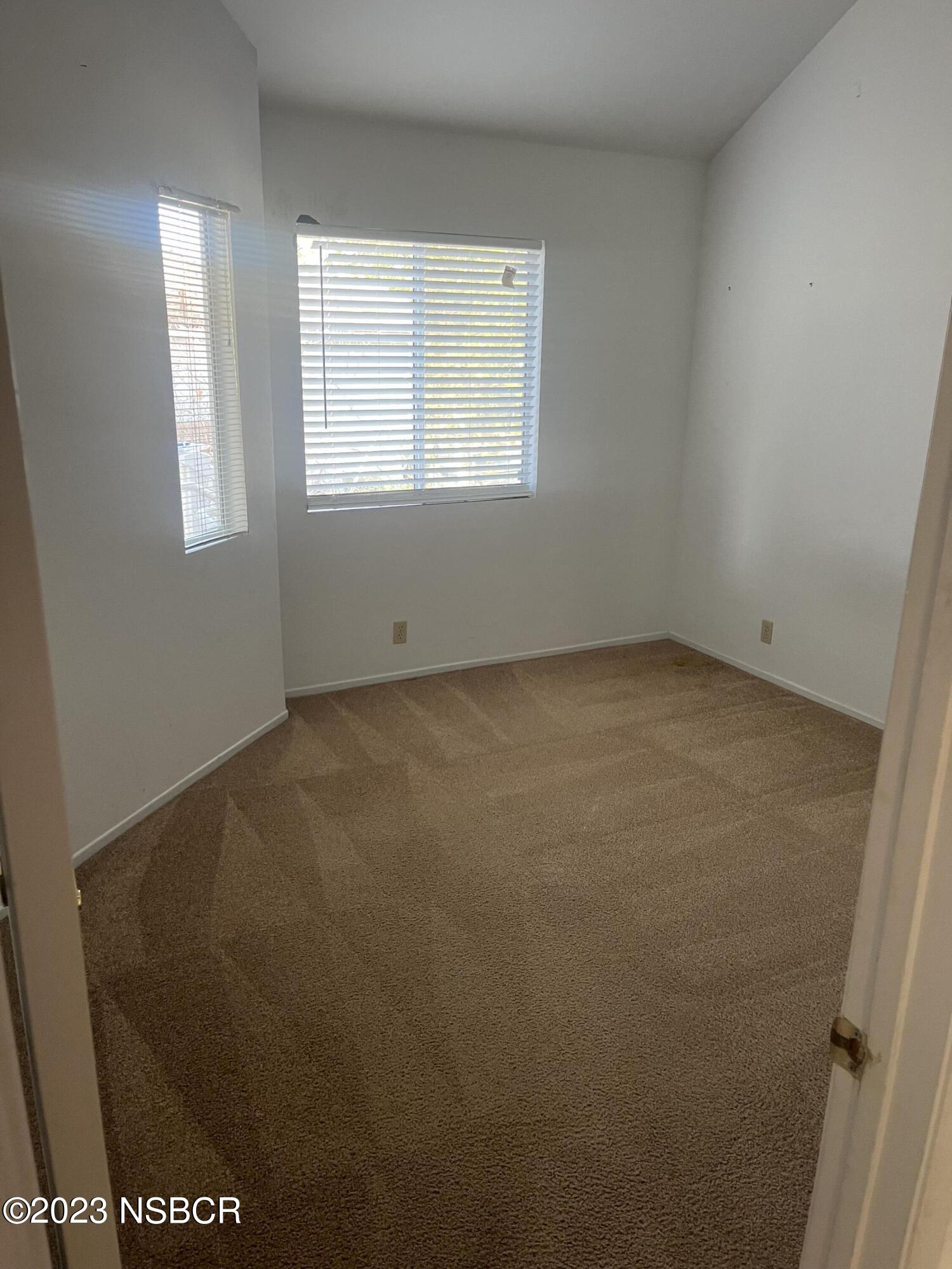 1674 Eucalyptus Drive, Unit C Solvang, CA 93463 - Photo 3 of 7 an empty room with windows