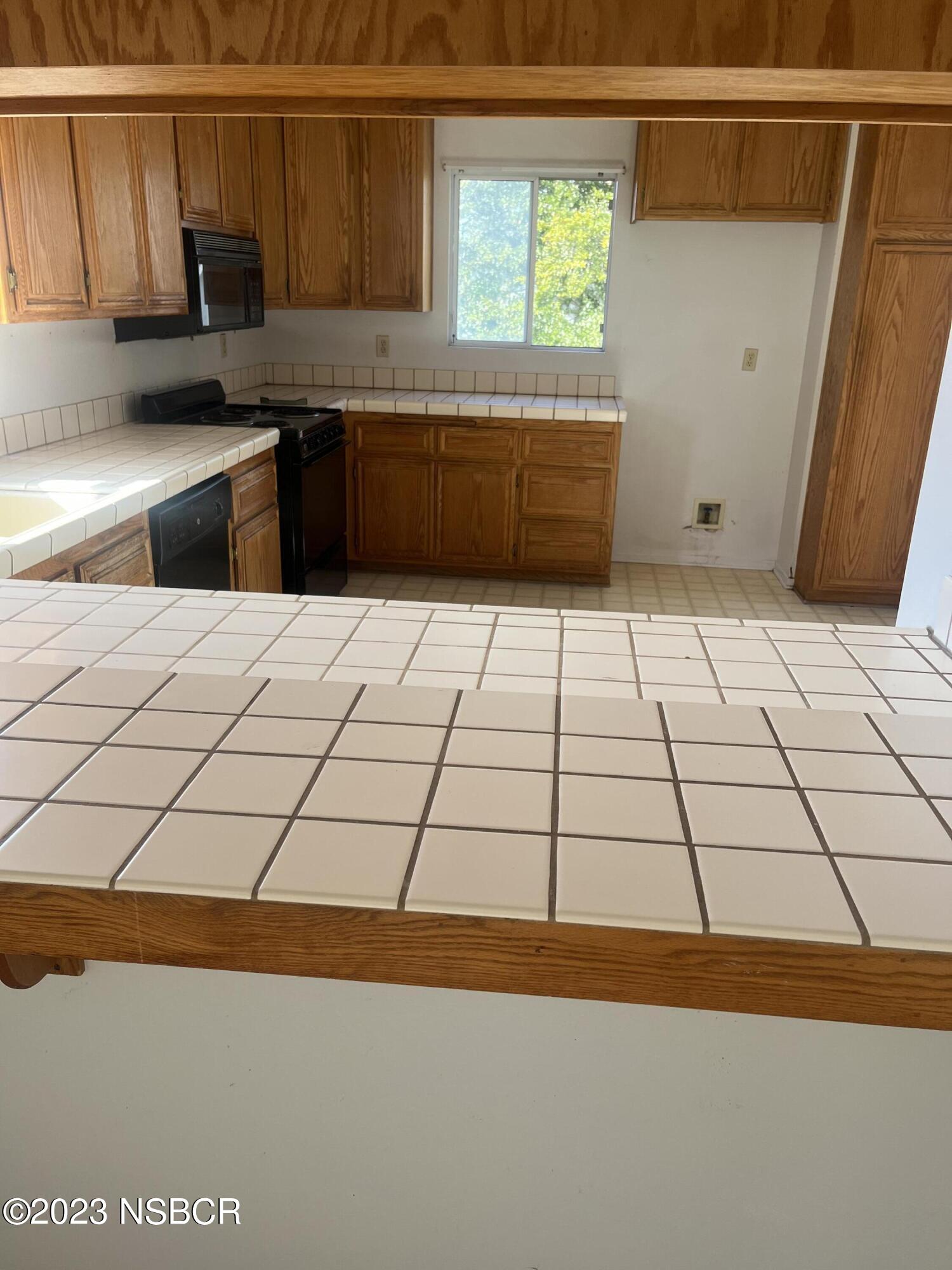 1674 Eucalyptus Drive, Unit C Solvang, CA 93463 - Photo 5 of 7 a kitchen with a sink and cabinets