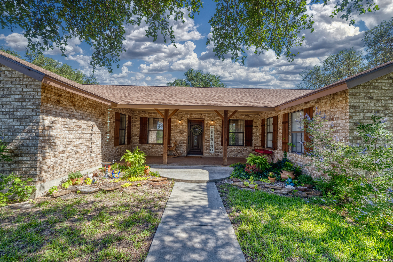 335 Sunset Ridge Road Uvalde, TX 78801 - Photo 5 of 8 a front view of a house with garden and plants