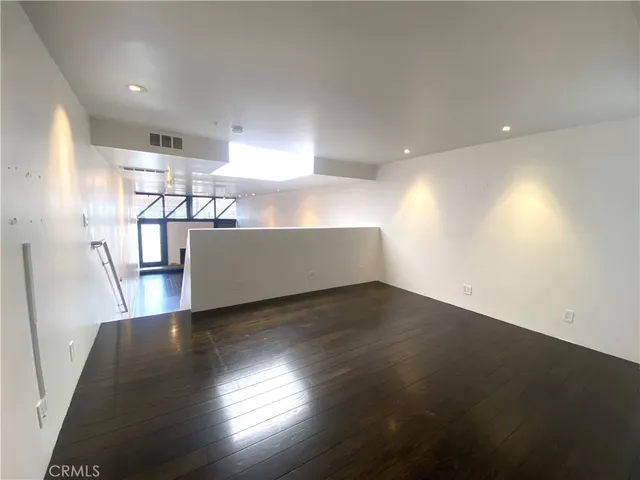 a view of a room with wooden floor