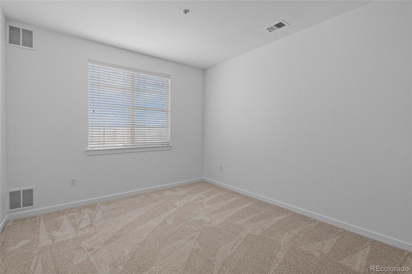 4100 Albion Street, Unit 320 Denver, CO 80216 - Photo 16 of 45 an empty room with a window