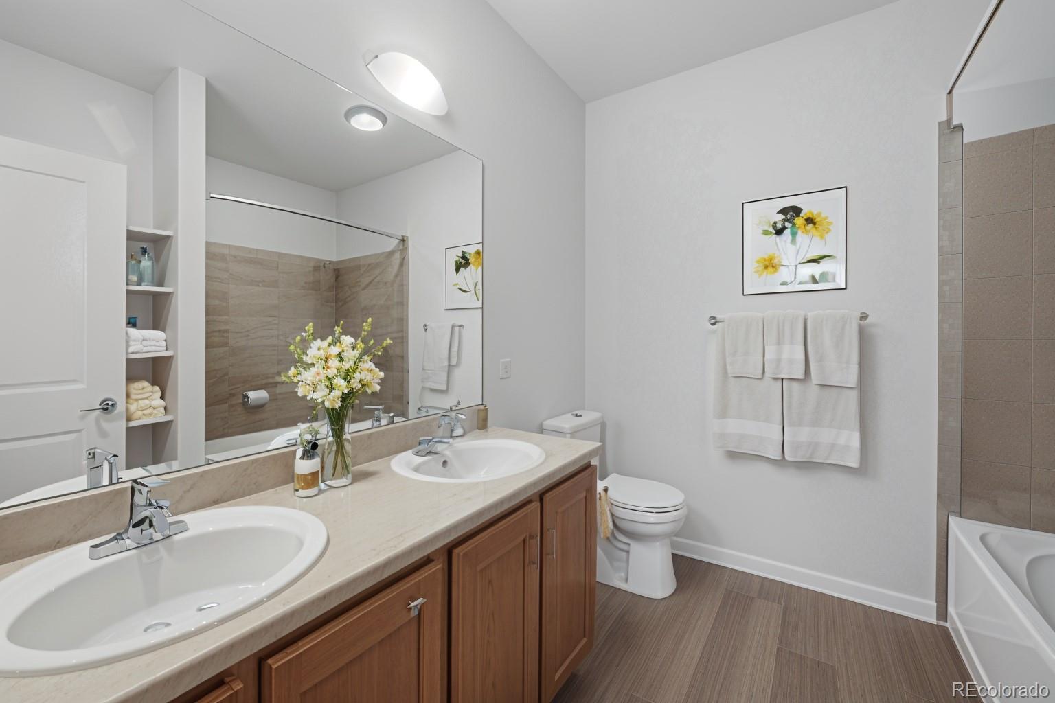 4100 Albion Street, Unit 320 Denver, CO 80216 - Photo 18 of 45 a bathroom with a sink and a mirror