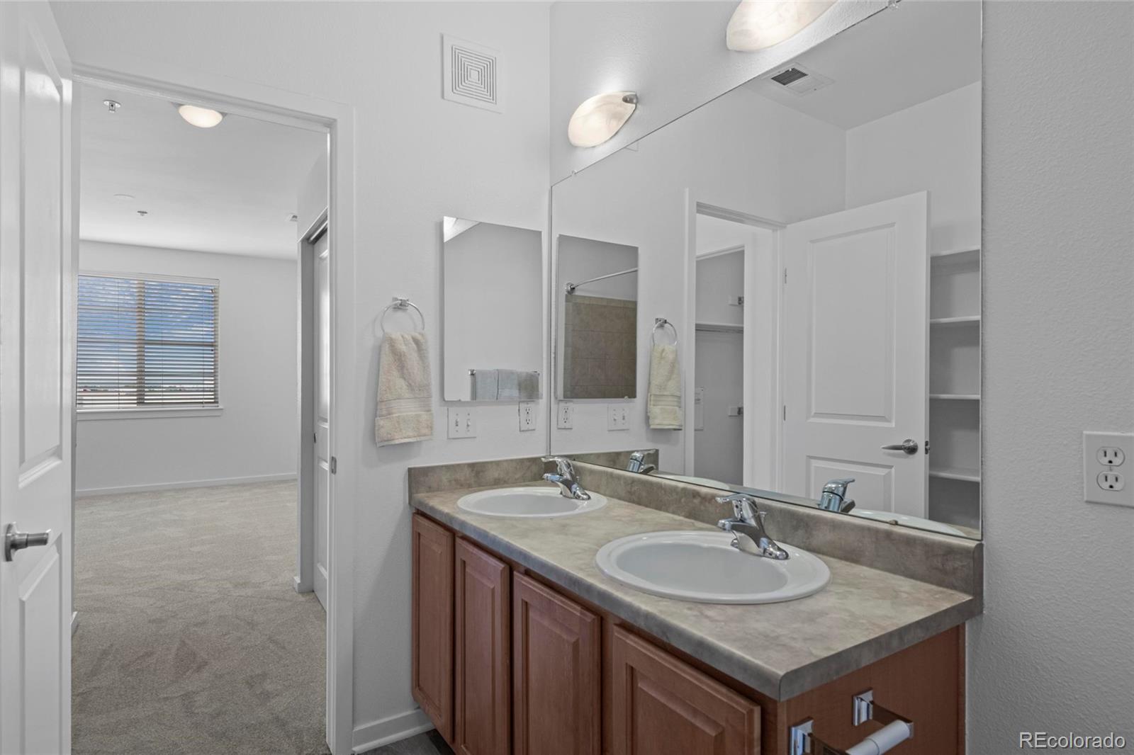 4100 Albion Street, Unit 320 Denver, CO 80216 - Photo 20 of 45 a bathroom with a sink and a mirror