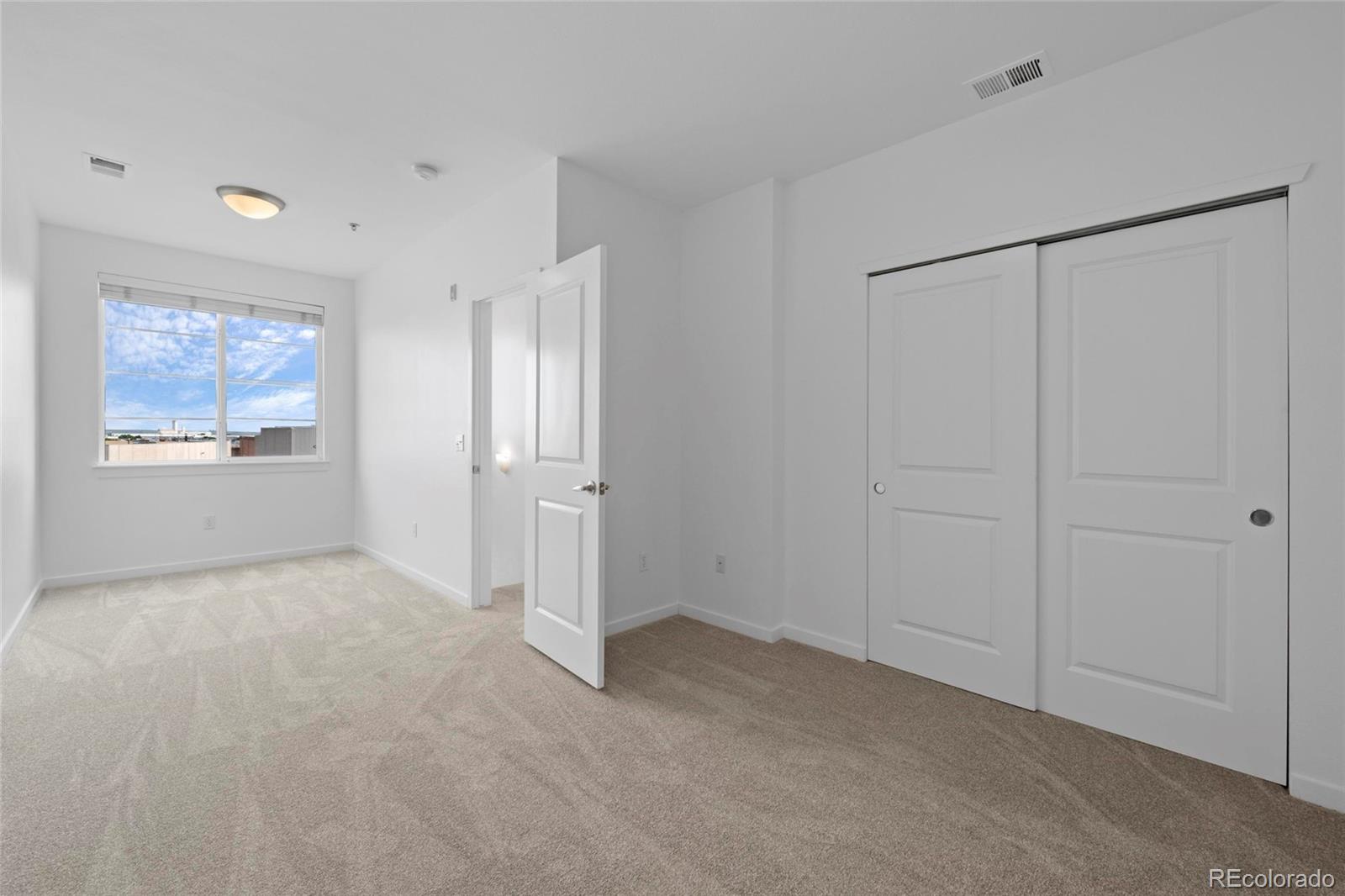 4100 Albion Street, Unit 320 Denver, CO 80216 - Photo 24 of 45 a view of an empty room with a window