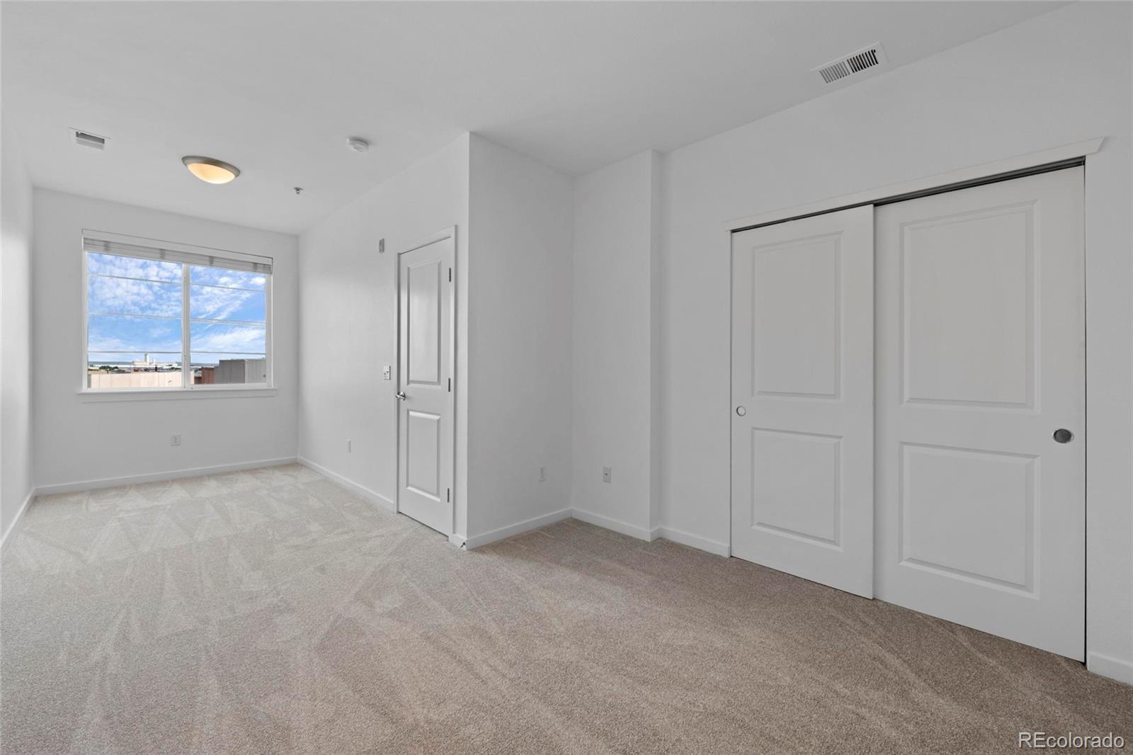 4100 Albion Street, Unit 320 Denver, CO 80216 - Photo 25 of 45 a view of an empty room with a window