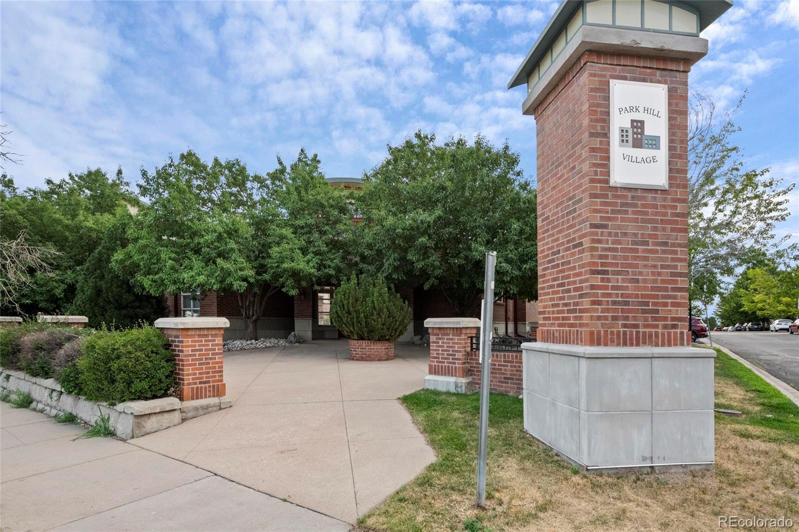4100 Albion Street, Unit 320 Denver, CO 80216 - Photo 34 of 45 a backyard of a house with fountain and outdoor seating