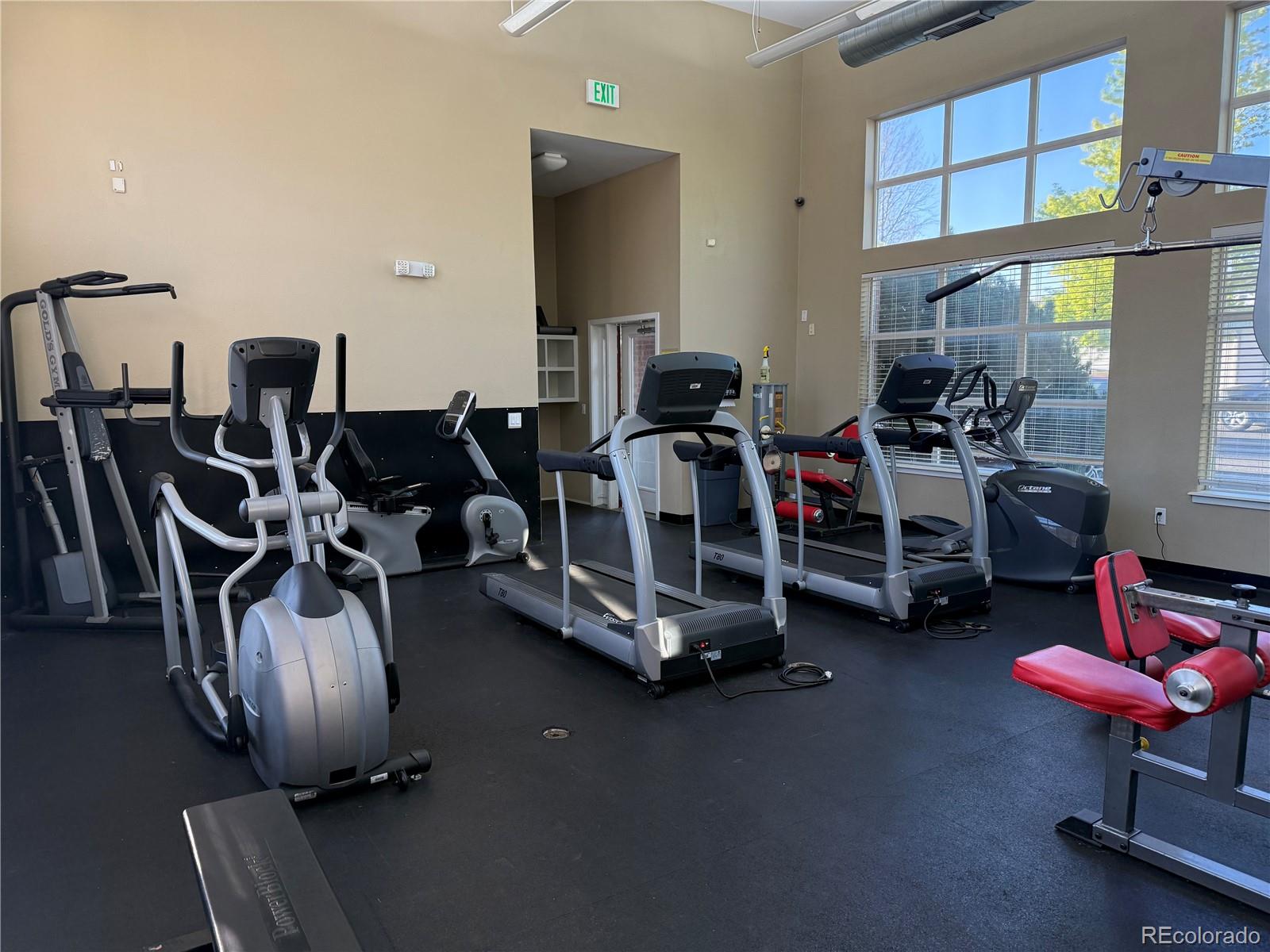 4100 Albion Street, Unit 320 Denver, CO 80216 - Photo 36 of 45 a room with gym equipment and large mirror