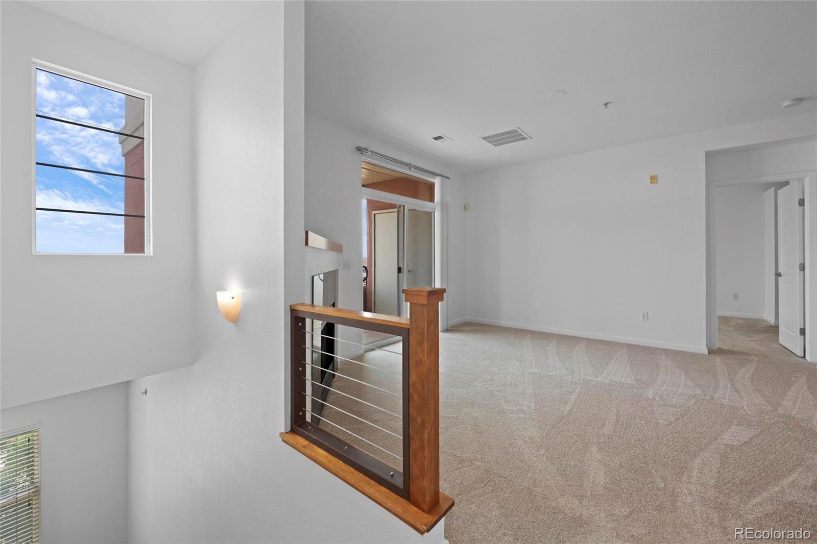 4100 Albion Street, Unit 320 Denver, CO 80216 - Photo 6 of 45 a view of wooden floor and a window in a room
