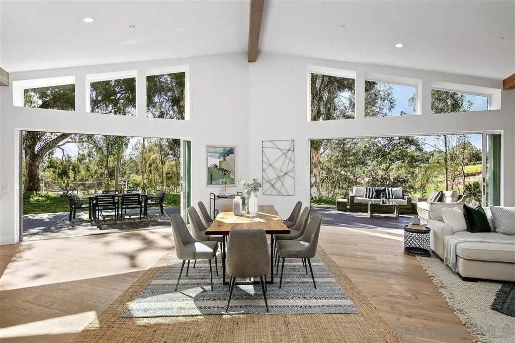 17502 Rancho Del Rio Rancho Santa Fe, CA 92067 - Photo 2 of 20 a dining room with wooden floor and windows