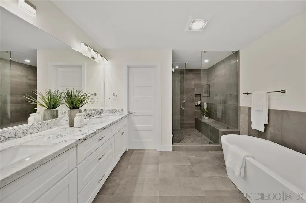 17502 Rancho Del Rio Rancho Santa Fe, CA 92067 - Photo 10 of 20 a bathroom with a granite countertop sink mirror and a
