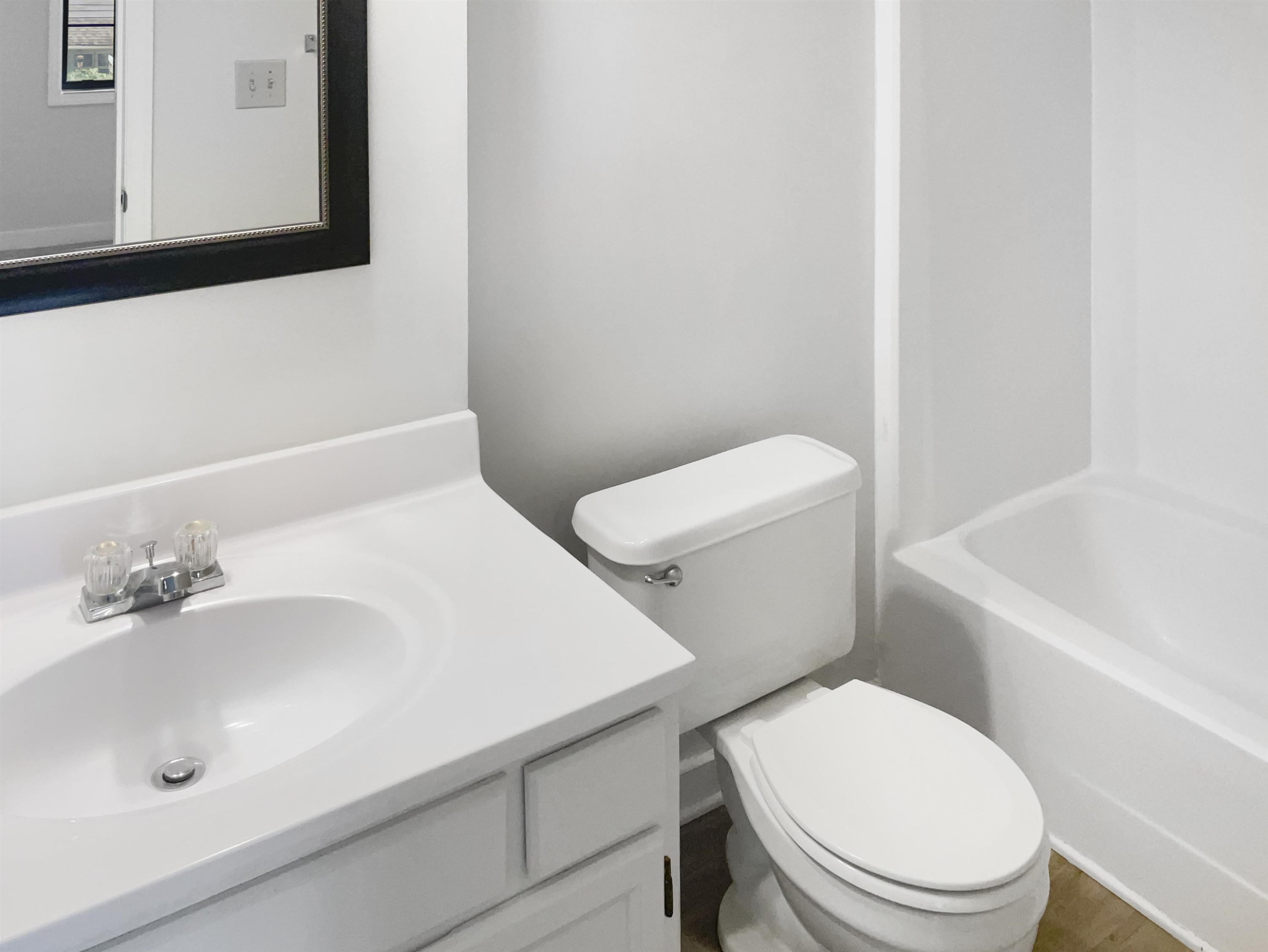 46 Willow Bridge Drive Durham, NC 27707 - Photo 27 of 29 a white toilet sitting next to a bathroom sink