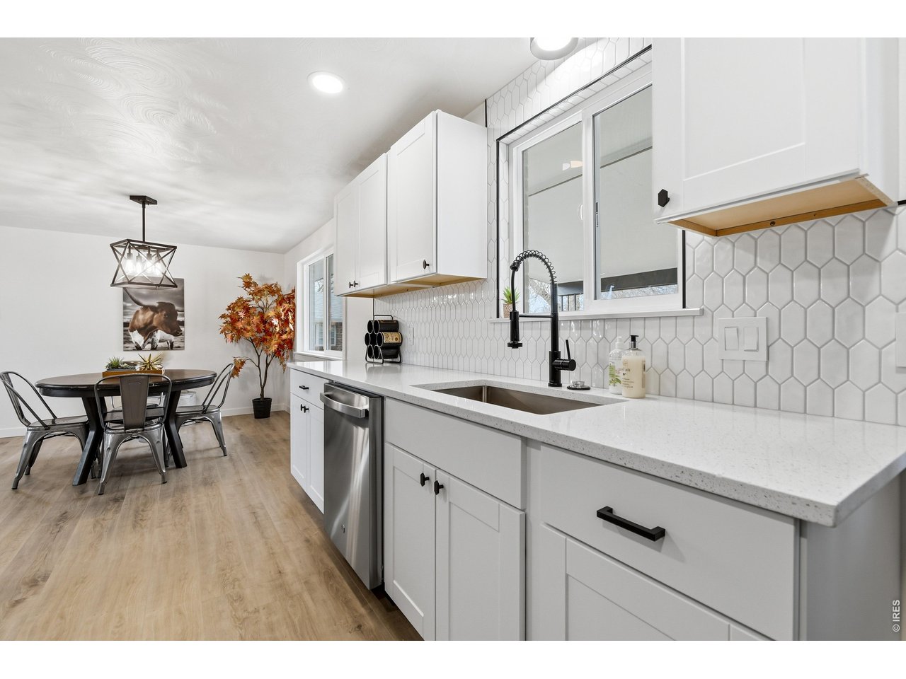 1239 Sunset Street Longmont, CO 80501 - Photo 12 of 34 a kitchen with a sink cabinets and wooden floor