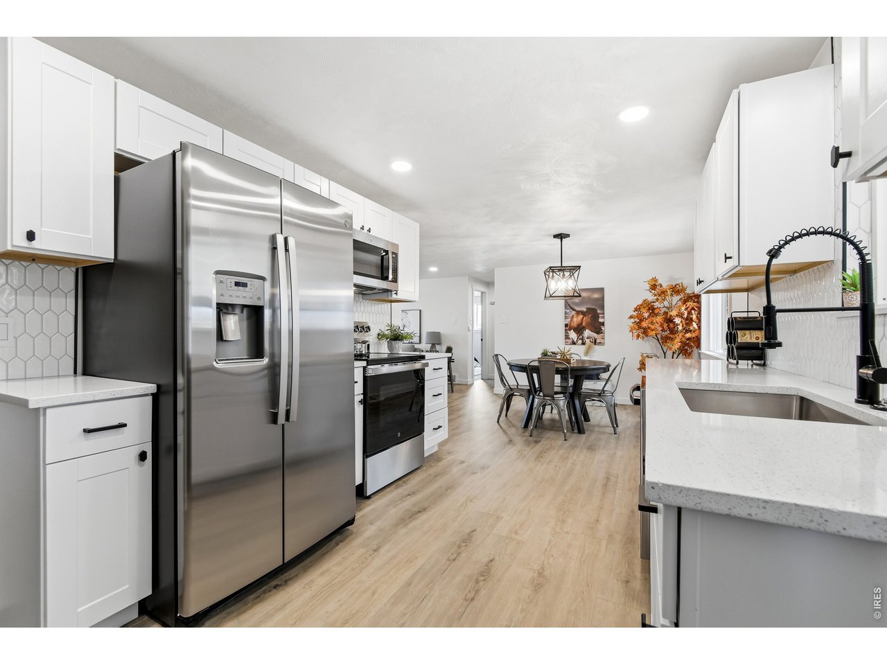 1239 Sunset Street Longmont, CO 80501 - Photo 13 of 34 a kitchen with stainless steel appliances granite countertop a refrigerator and a sink