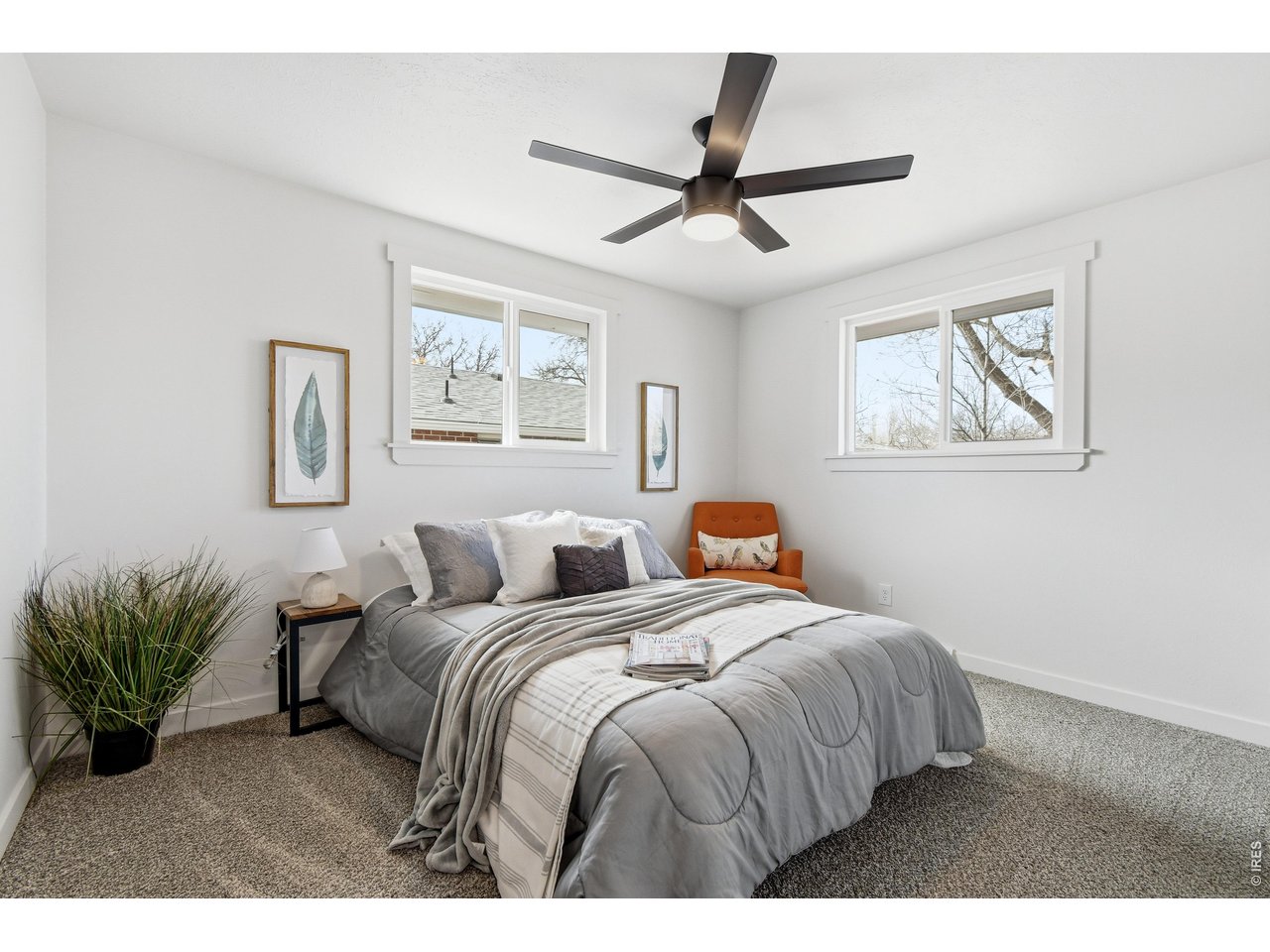 1239 Sunset Street Longmont, CO 80501 - Photo 22 of 34 a bedroom with a large bed and a chandelier