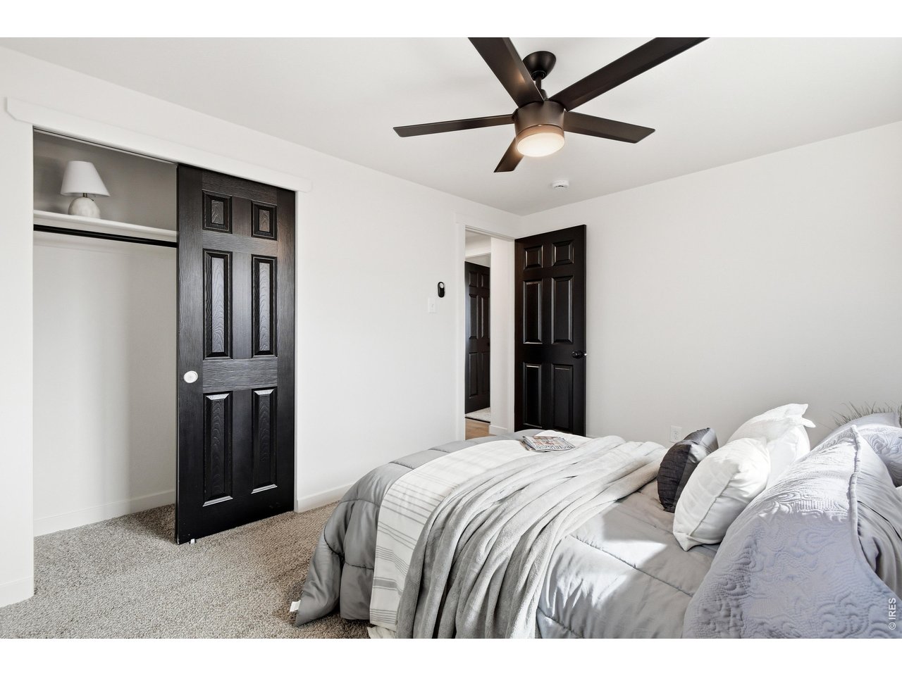 1239 Sunset Street Longmont, CO 80501 - Photo 24 of 34 a bedroom with a bed and a ceiling fan