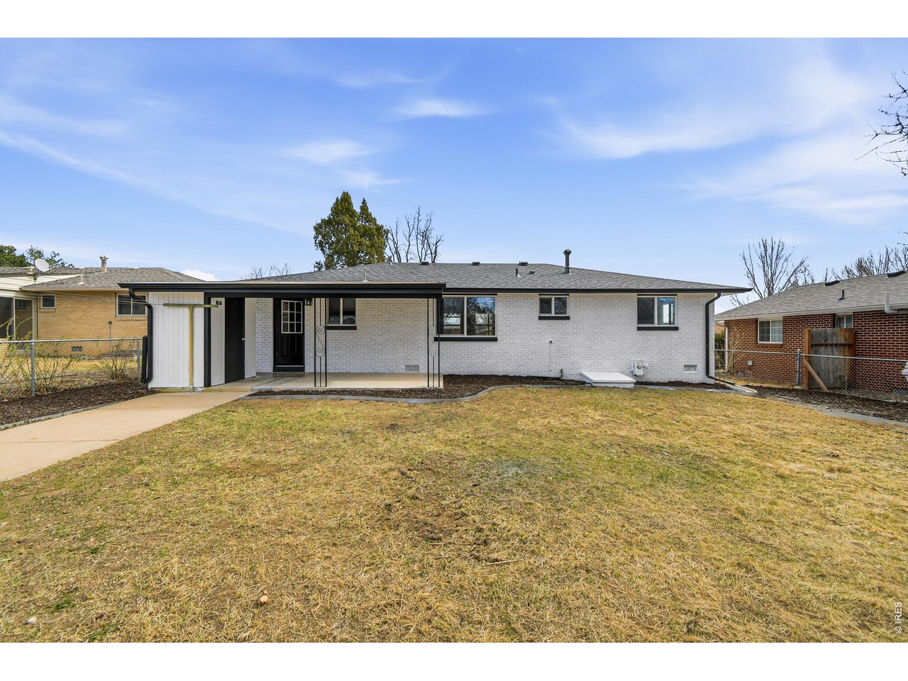 1239 Sunset Street Longmont, CO 80501 - Photo 33 of 34 a front view of a house with a garden