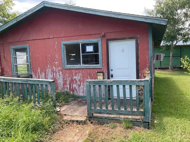 a view of front door of house with a yard