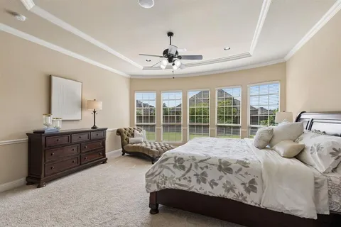 a bedroom with a bed dresser and a window