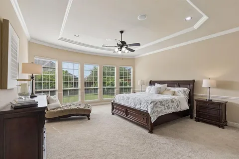 a spacious bedroom with a bed and a couch