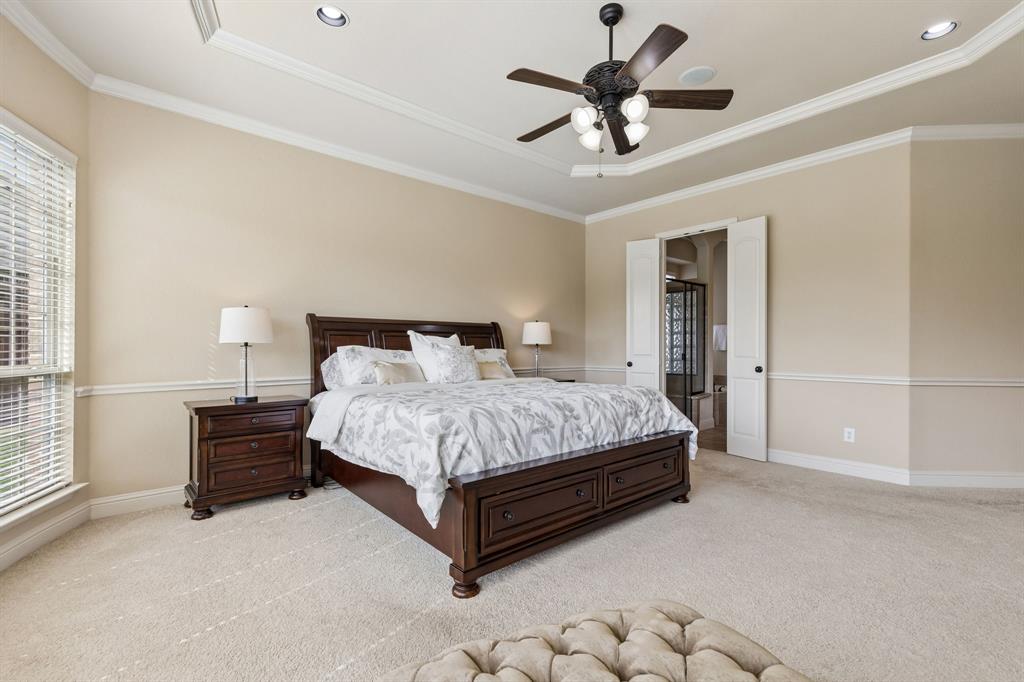 2701 Brunswick Cove Trophy Club, TX 76262 - Photo 21 of 40 a bedroom with a bed and a ceiling fan