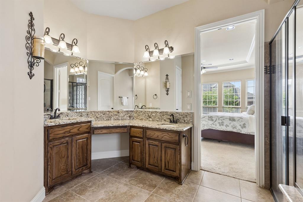 2701 Brunswick Cove Trophy Club, TX 76262 - Photo 23 of 40 a bathroom with a granite countertop sink a large mirror and a window