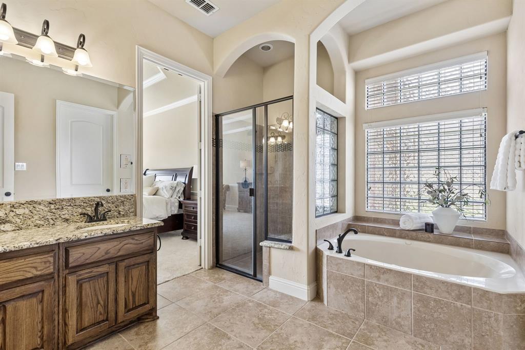 2701 Brunswick Cove Trophy Club, TX 76262 - Photo 24 of 40 a spacious bathroom with a tub sink shower and mirror