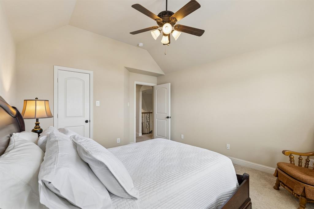 2701 Brunswick Cove Trophy Club, TX 76262 - Photo 29 of 40 a bedroom with a bed and a chandelier