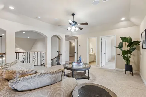 a living room with furniture a chandelier and a rug