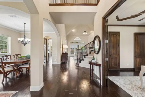 a view of a hallway with wooden floor fireplace and dining room