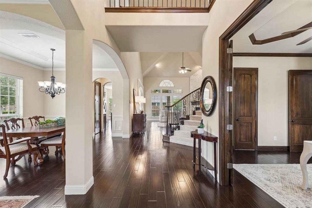 2701 Brunswick Cove Trophy Club, TX 76262 - Photo 5 of 40 a view of a hallway with wooden floor fireplace and dining room