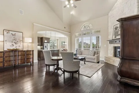 a living room with furniture and wooden floor