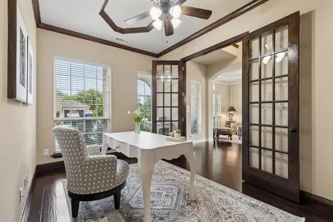 a dining room with furniture a chandelier and wooden floor